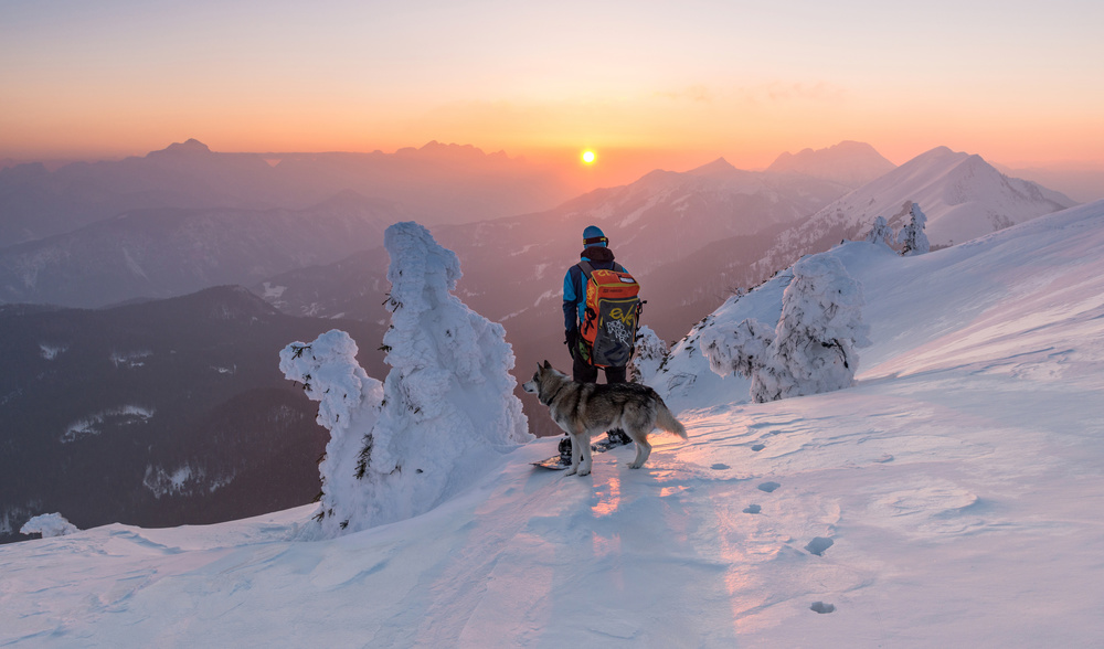 Snowboarder and his dog von Ales Krivec