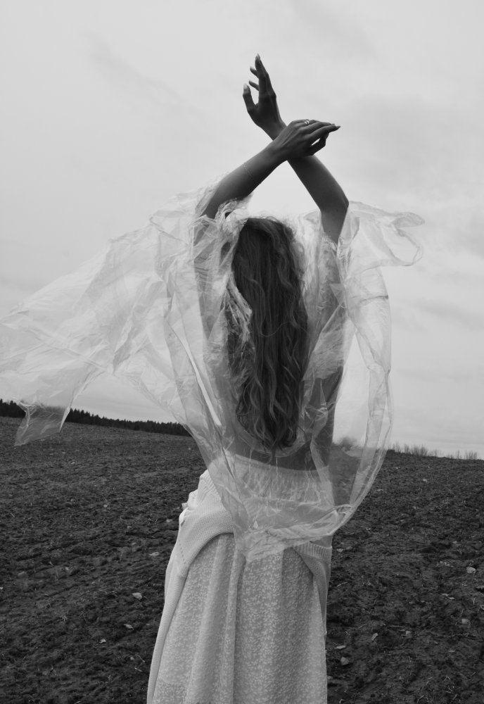 Topless girl in a transparent raincoat under the cold wind. von Alesia Mikhailova