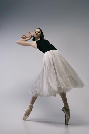 The courage. a young ballerina in a black skirt and Chopin is standing on pointe shoes