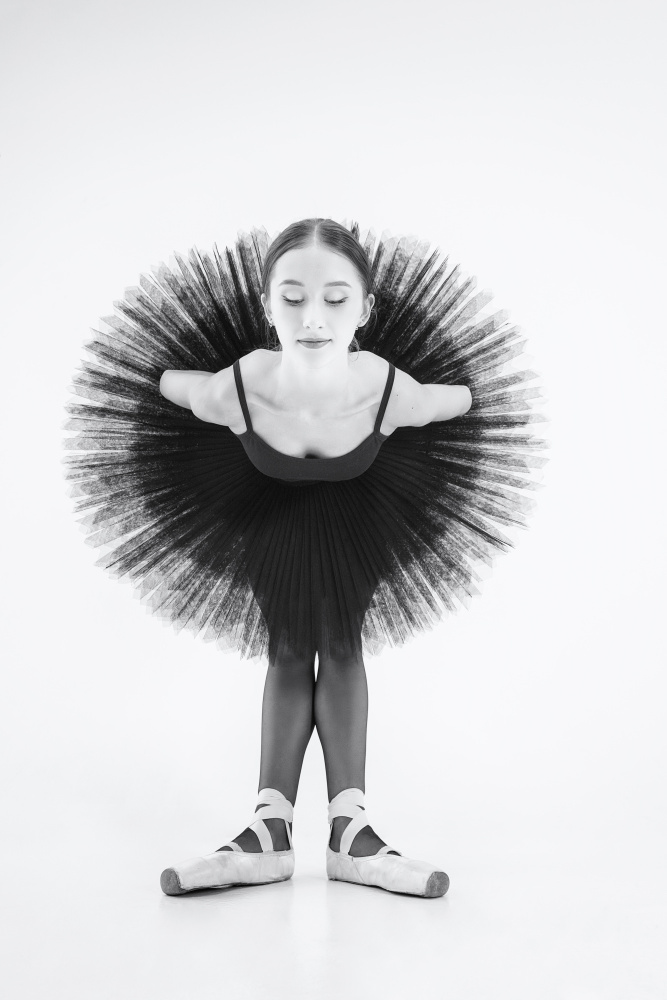 peacock. a ballerina in a black tutu is leaning forward with her arms crossed behind her back von Alexandr