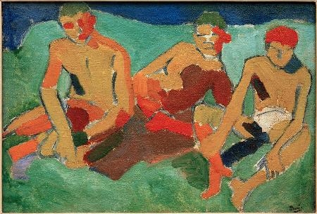 Three figures sitting on the grass