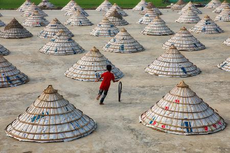 Children playing in the rice mill.