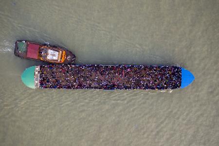 Migrant people are seen on an overcrowded ferry to get home to celebrate Eid al-Fitr