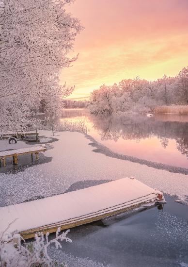 Frozen jetty and pink sunset