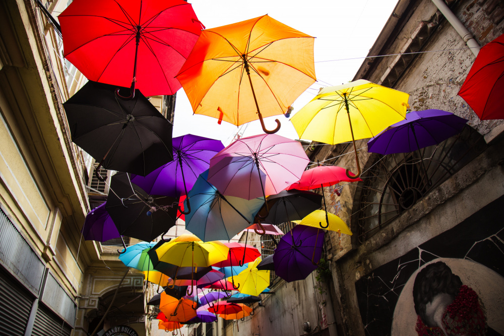 old building and decorative umbrellas von engin akyurt