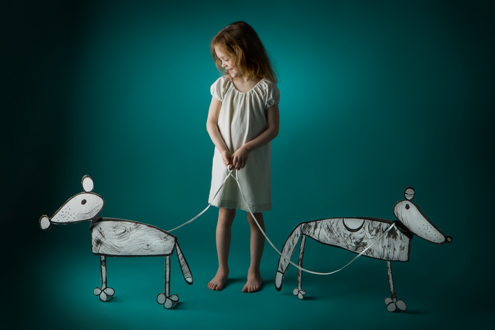 Girl with her dogs von Eva Miliuniene