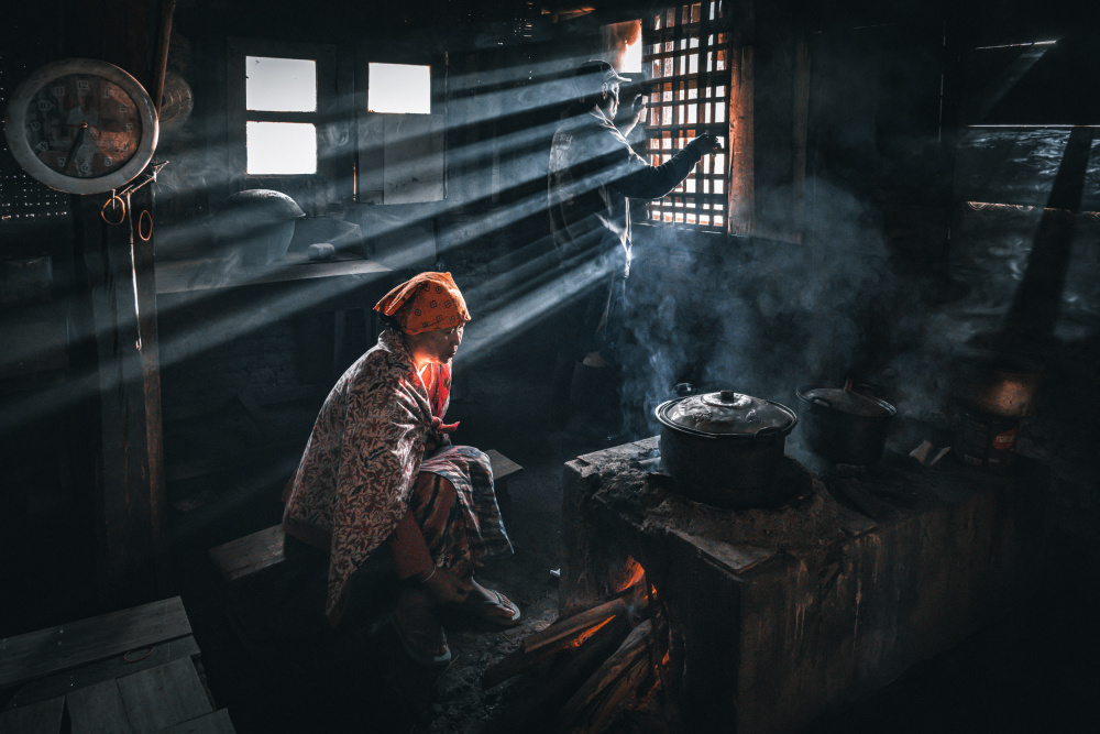 A village granny preparing a meal von Joseph Ng