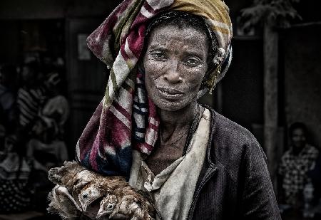 Ethiopian woman with chickens in a market