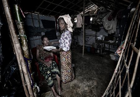 Feeding a disabled woman - Rohingya refugee people.