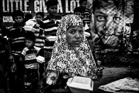 Distributing food in boxes to Rohingyas children: give a little. give a lot.