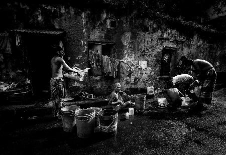 People cleaning themself in the streets of Calcutta.