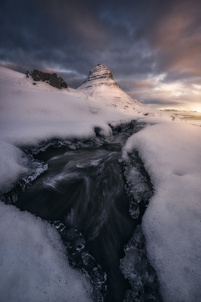 Rushing Water under the Mountain Peak von Manuel Martin