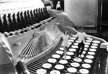 Couple dancing on the key of a giant typewriter, keys are leg of dancers, musical