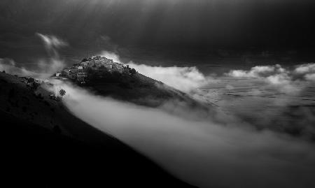 Village over the melting clouds