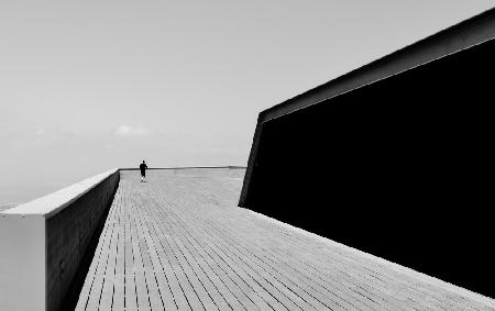 Man on wooden terrace BW