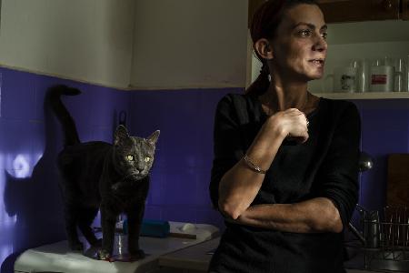 Woman with cat in the kitchen